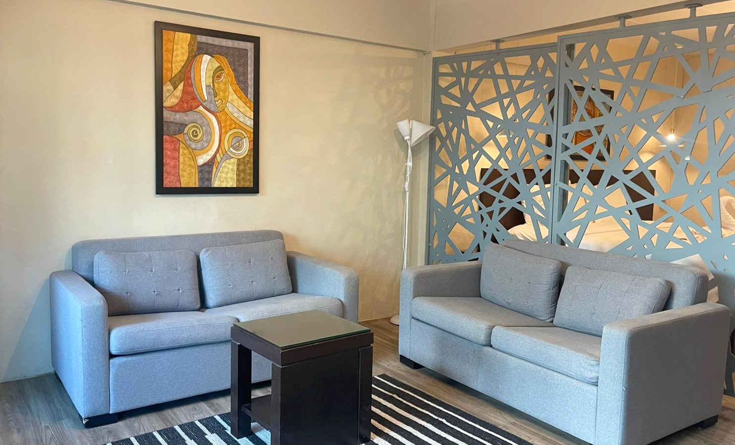 Suite lounge with two sofas and a decorative room divider